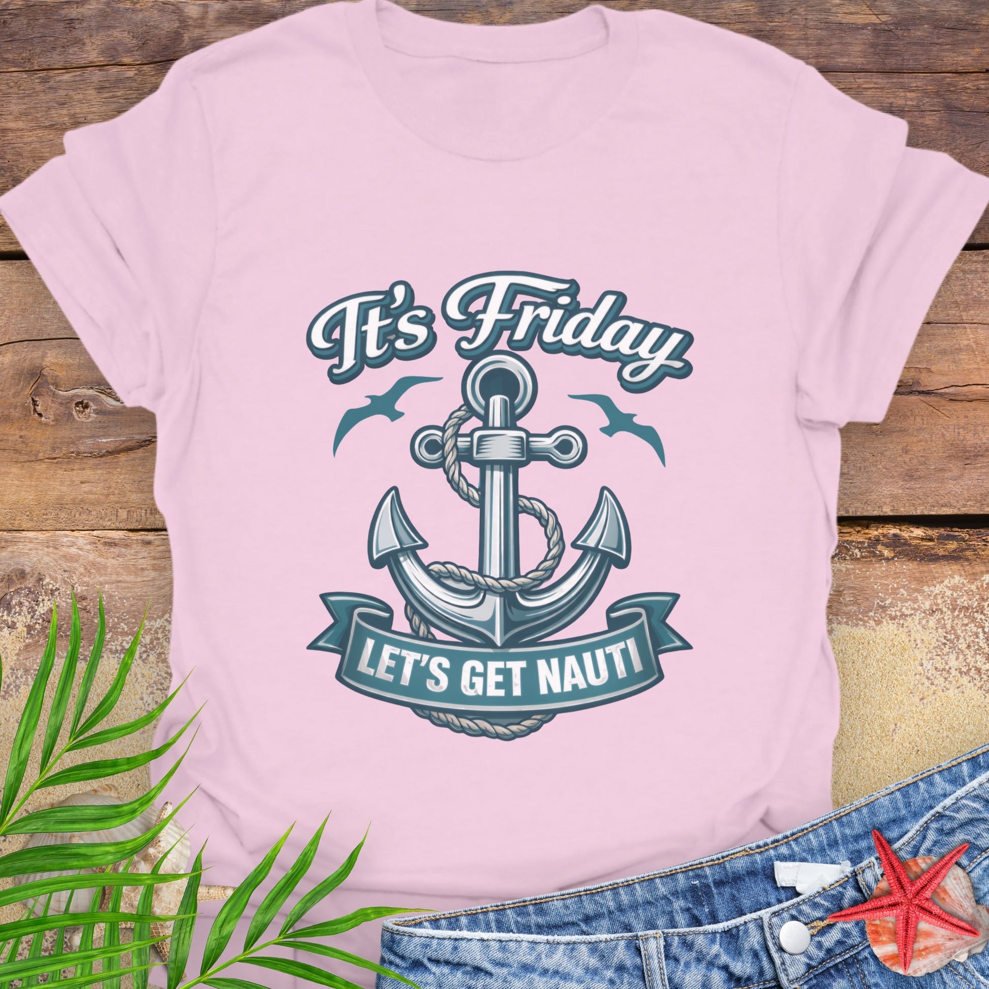 Pink unisex t-shirt with a nautical anchor design and text “It’s Friday Let’s Get Nauti”.