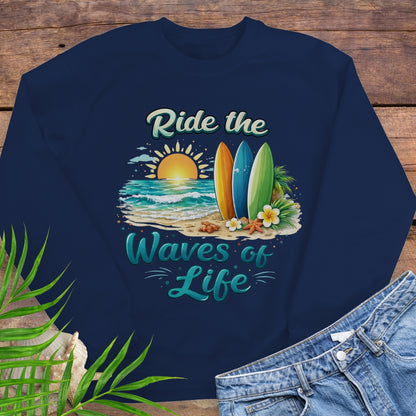 Navy blue crewneck sweatshirt with inspirational Ride the Waves of Life beach design, showing surfboards, ocean sunset, palm leaves, and sand.