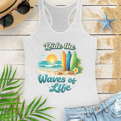 White Women's racerback tank top with a scooped neckline, side seams for a fitted silhouette, and lightweight cotton-poly fabric. Features the 'Ride the Waves of Life' beach graphic on the front.