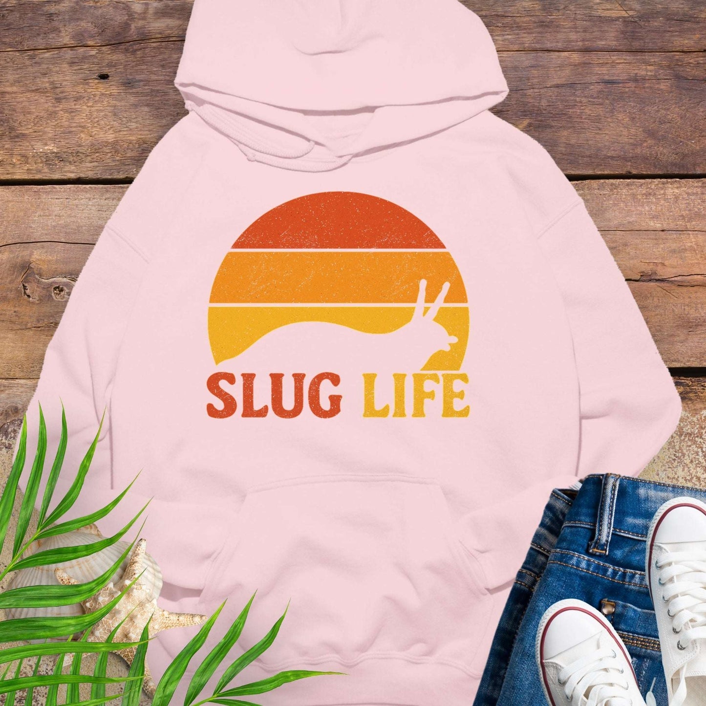 Pink hoodie with 'SLUG LIFE' retro sunset design.