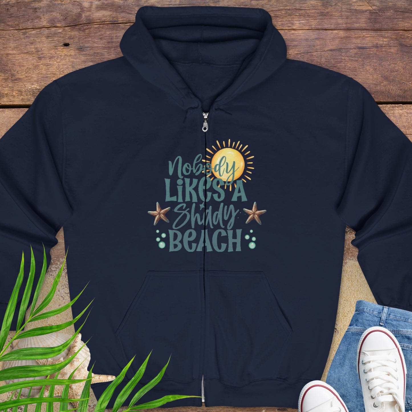 Navy blue hoodie with beach-themed graphics and text Nobody Likes a Shady Beach.