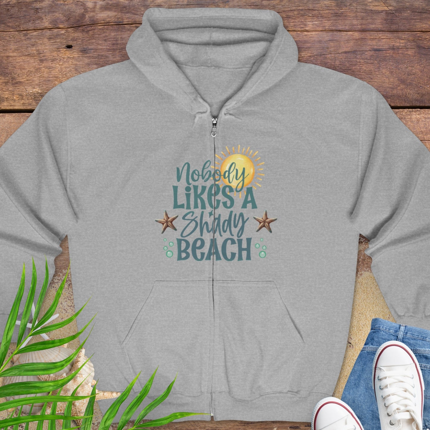 Gray hoodie with beach-themed graphics and text Nobody Likes a Shady Beach.