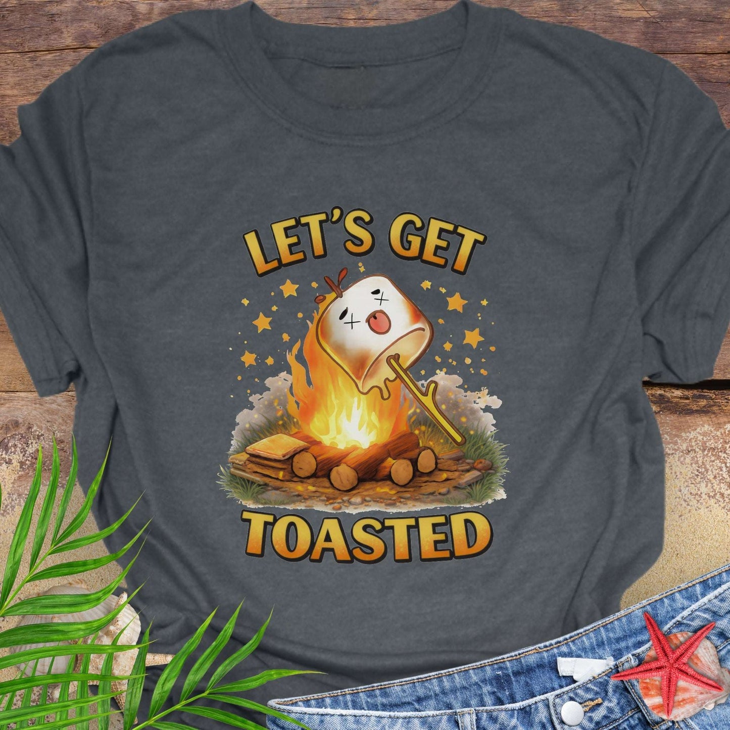 Gray t-shirt with a graphic of a marshmallow over a campfire and text 'Let's Get Toasted.