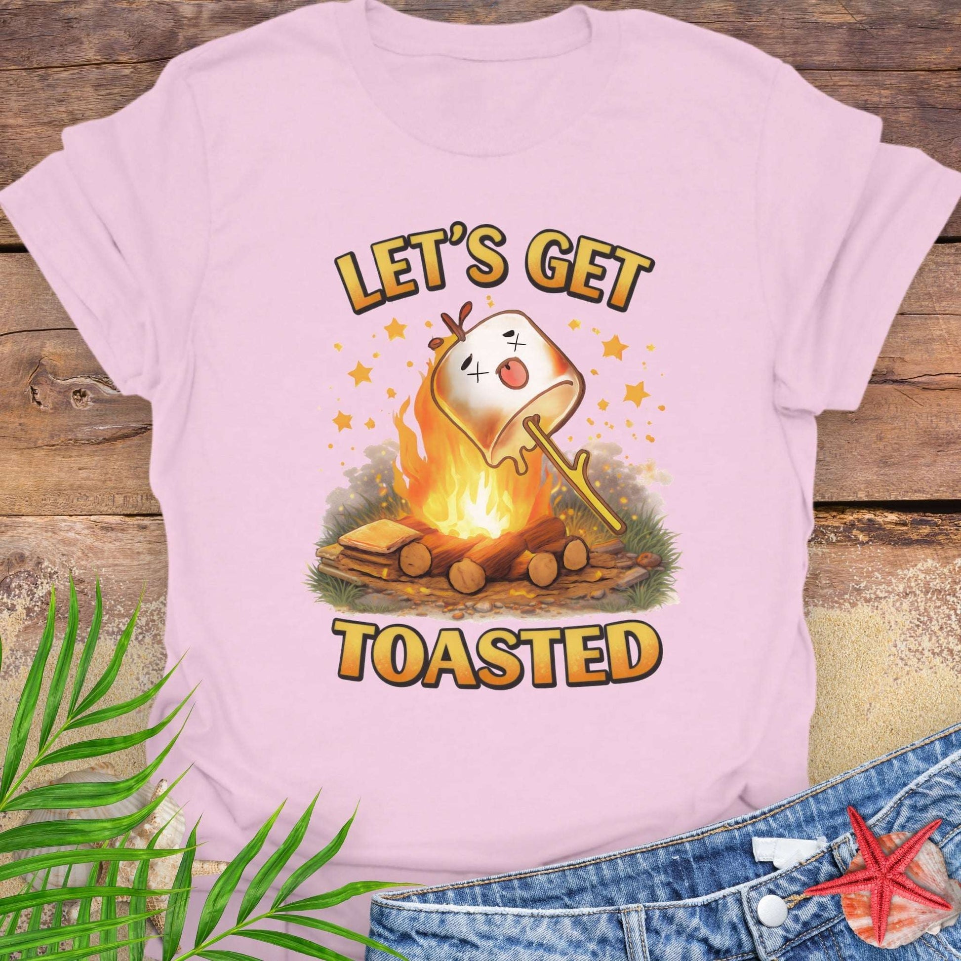 Pink t-shirt with a graphic of a marshmallow over a campfire and text 'Let's Get Toasted.