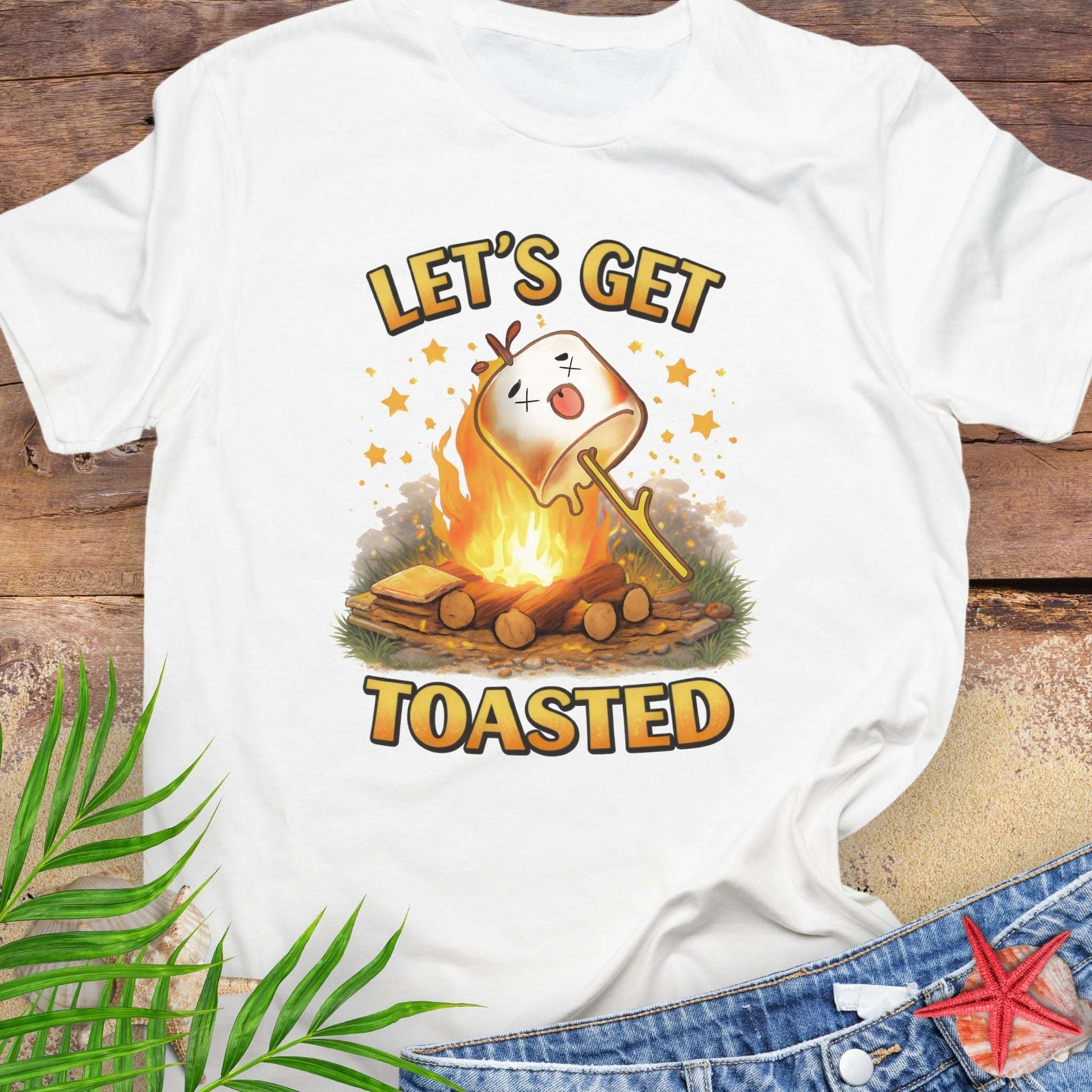 White t-shirt with a graphic of a marshmallow over a campfire and text 'Let's Get Toasted.