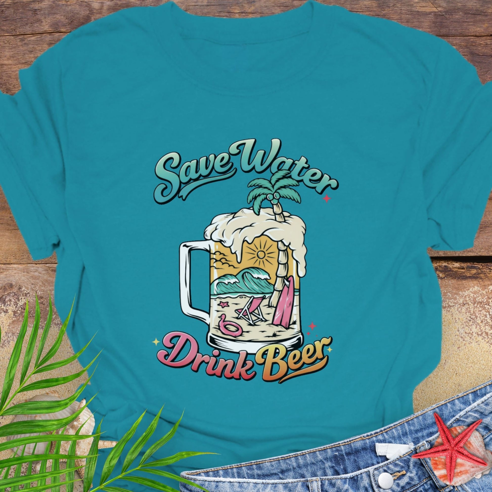 Teal unisex t-shirt with “Save Water Drink Beer” in colorful retro text and a beach scene inside a beer mug