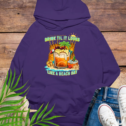 Purple pullover hoodie with a tropical cartoon beer mug, palm tree, sunglasses, and the text “Drink Til It Looks Like a Beach Day” in vibrant summer colors.