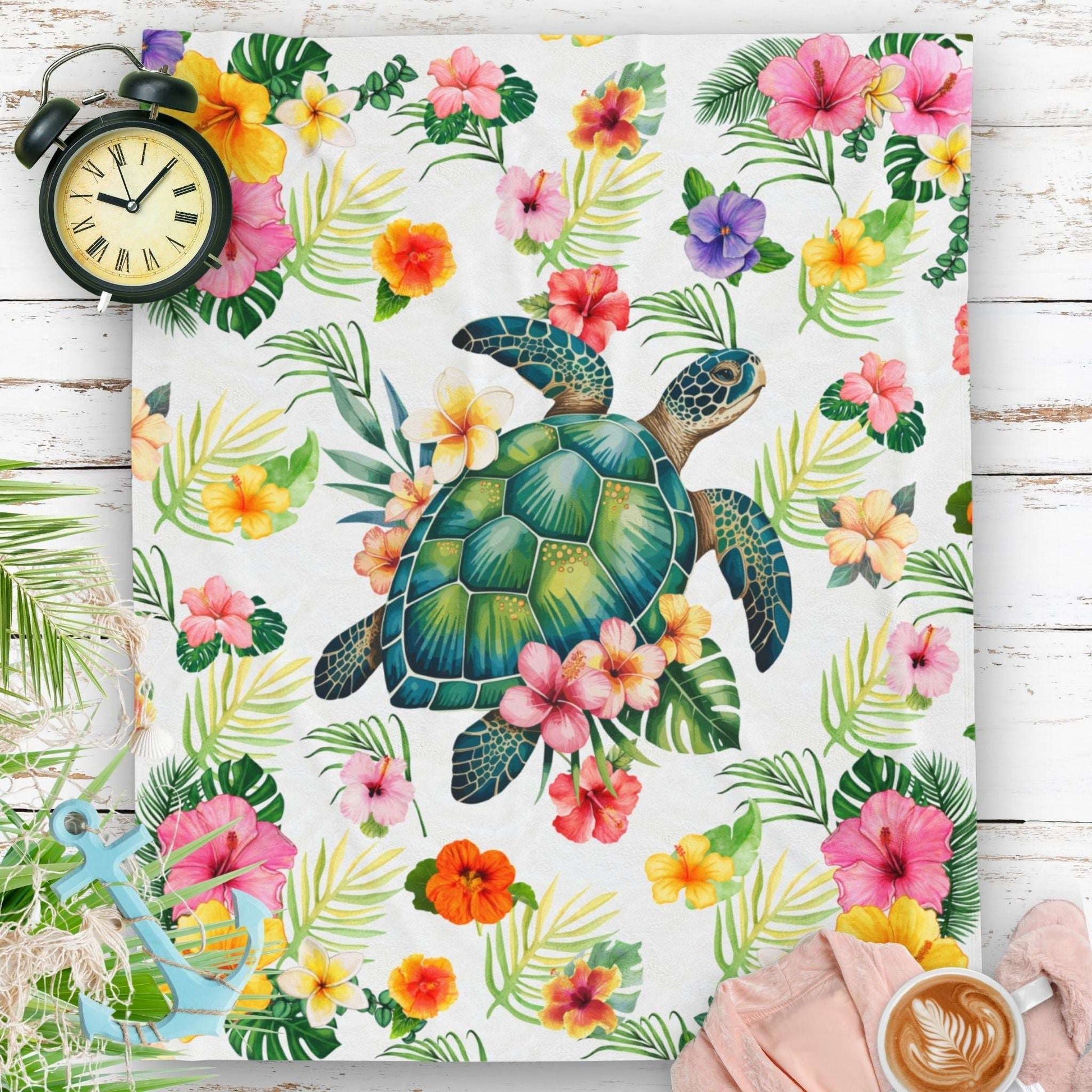 Cozy tropical velveteen throw blanket featuring a sea turtle surrounded by colorful hibiscus flowers and palm leaves, perfect for beachy home decor.