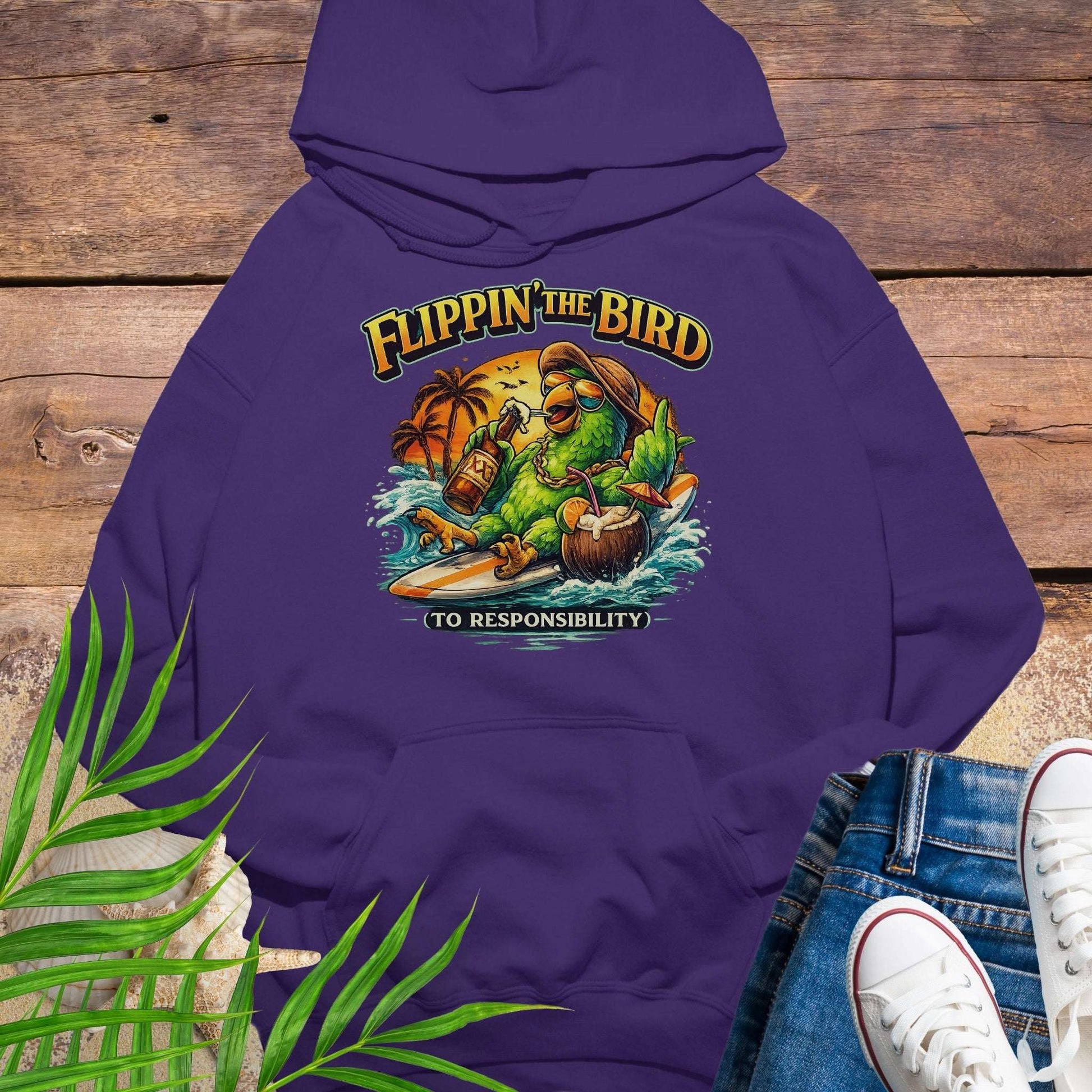 Purple tropical graphic hoodie featuring a green parrot surfing with sunglasses, holding a beer, with coconut drink and sunset palms; text reads “Flippin’ the Bird (to responsibility)”.