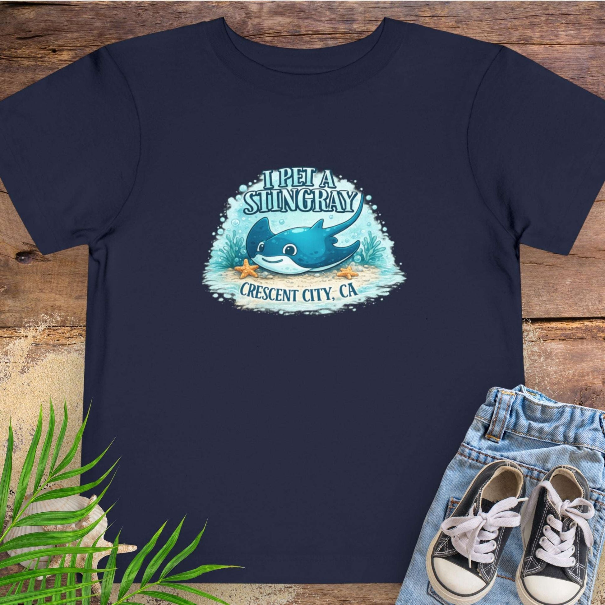 Navy blue t-shirt with a stingray graphic and text 'I Pet a Stingray Crescent City, CA'.