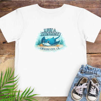 White t-shirt with a stingray graphic and text 'I Pet a Stingray Crescent City, CA'.
