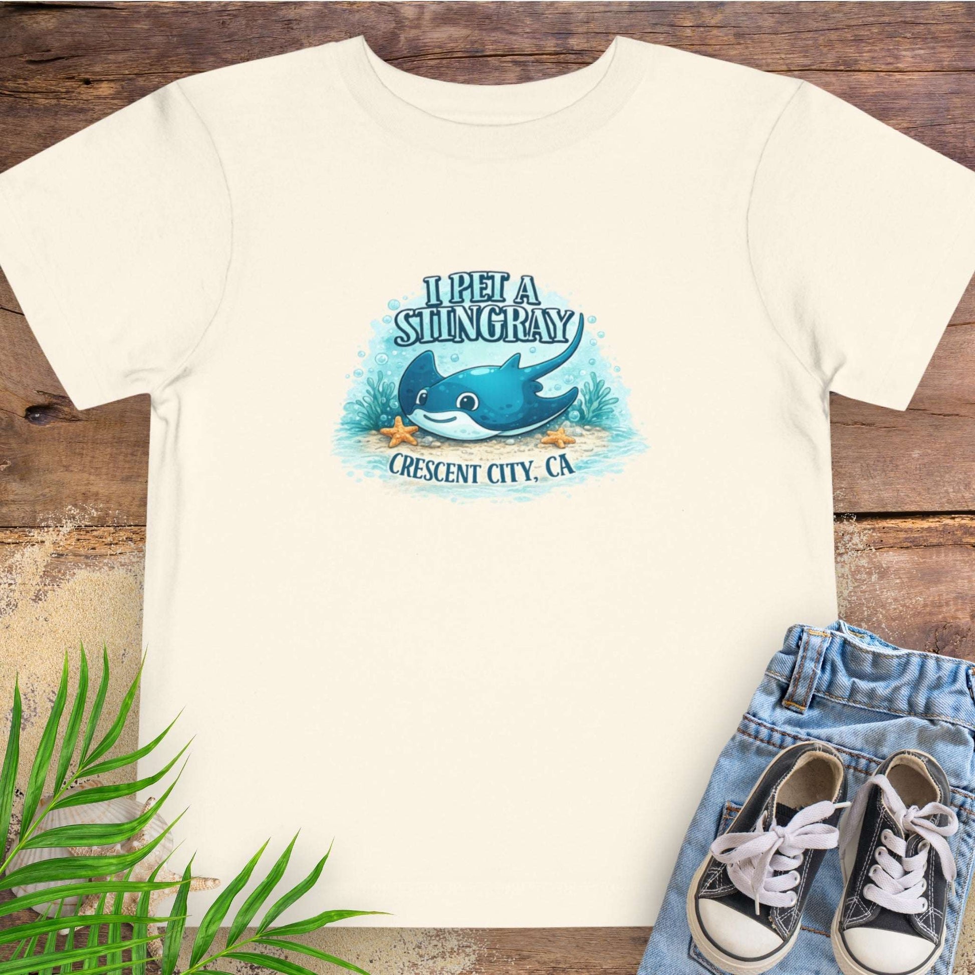 Light Beige t-shirt with a stingray graphic and text 'I Pet a Stingray Crescent City, CA'.