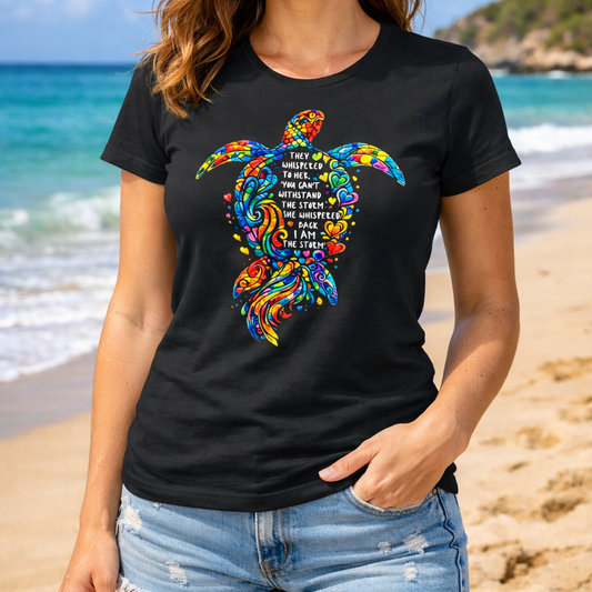Woman wearing a black t-shirt with a colorful sea turtle design with a motivational quote.
