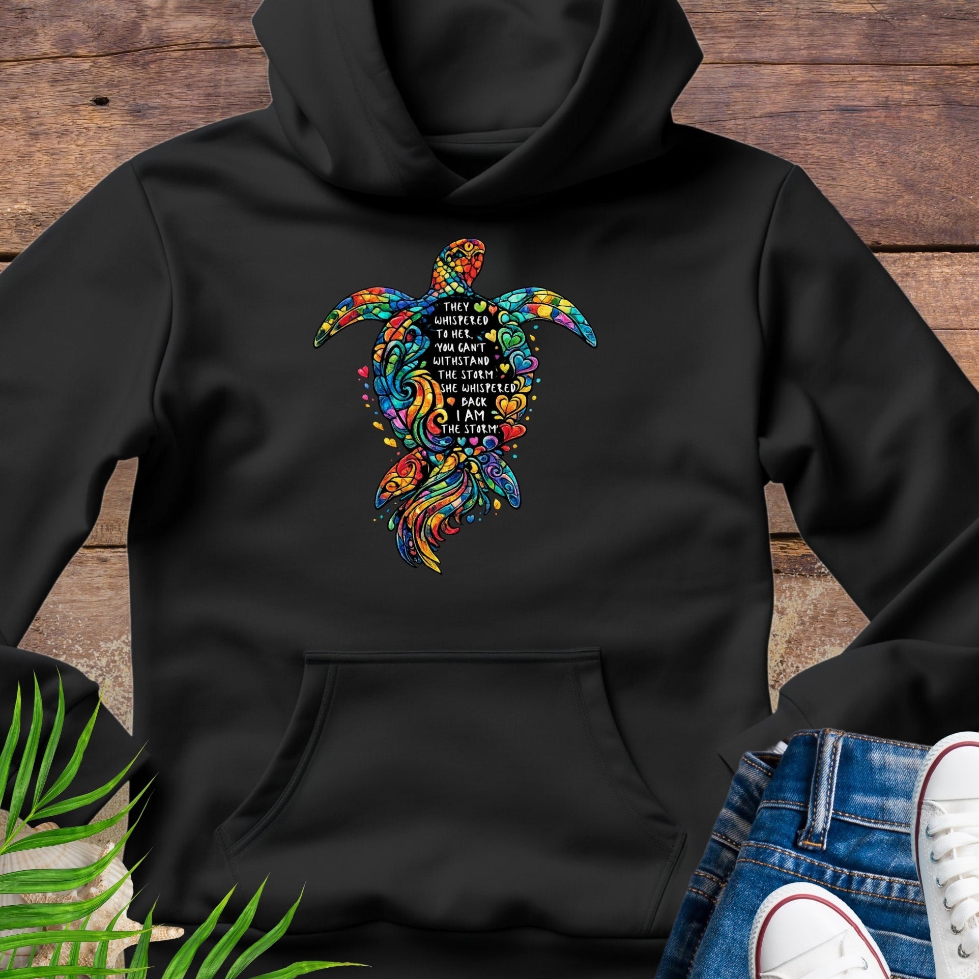 Black Unisex hoodie featuring sea turtle design with “I Am the Storm” inspirational quote in ocean colors.