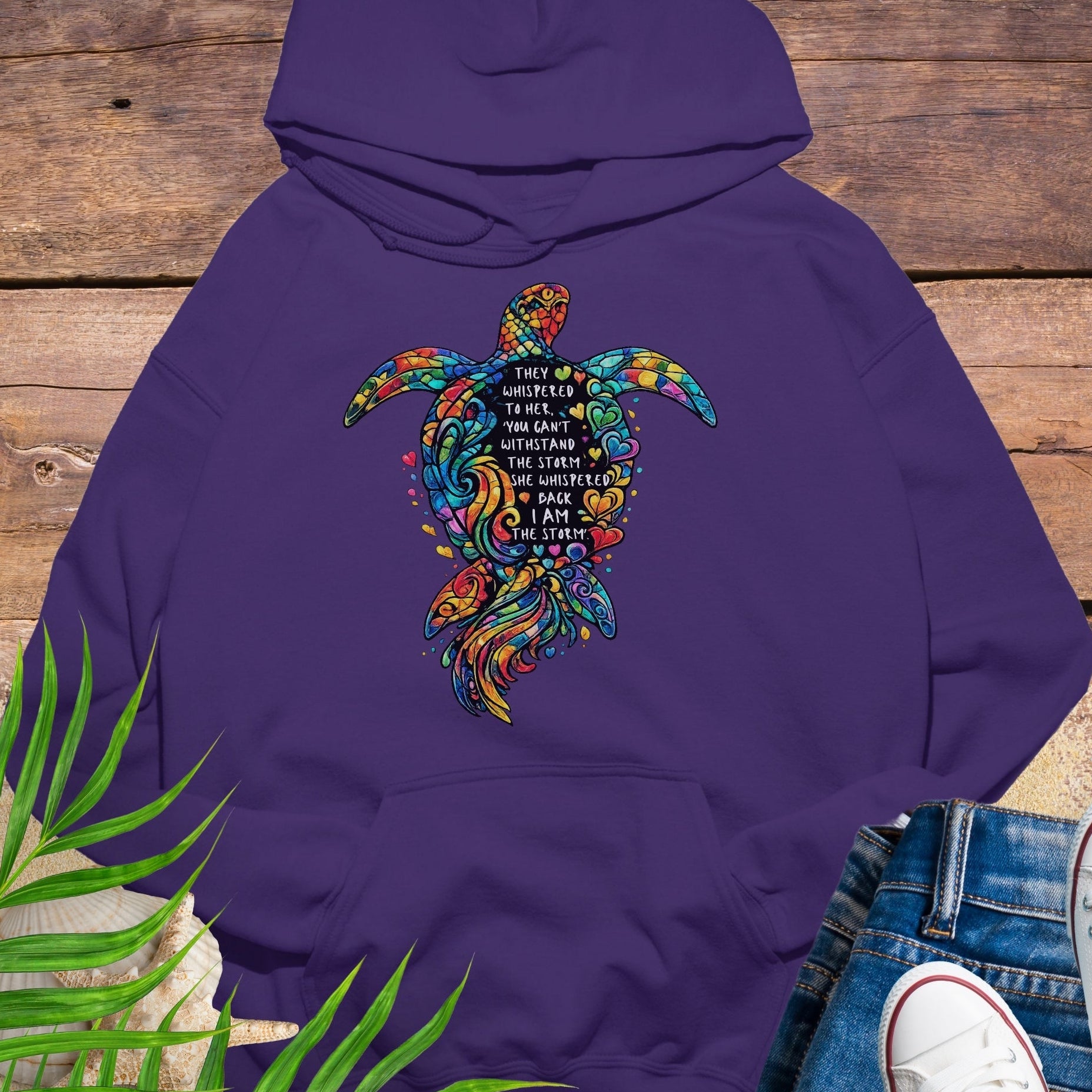 Purple Unisex hoodie featuring sea turtle design with “I Am the Storm” inspirational quote in ocean colors.