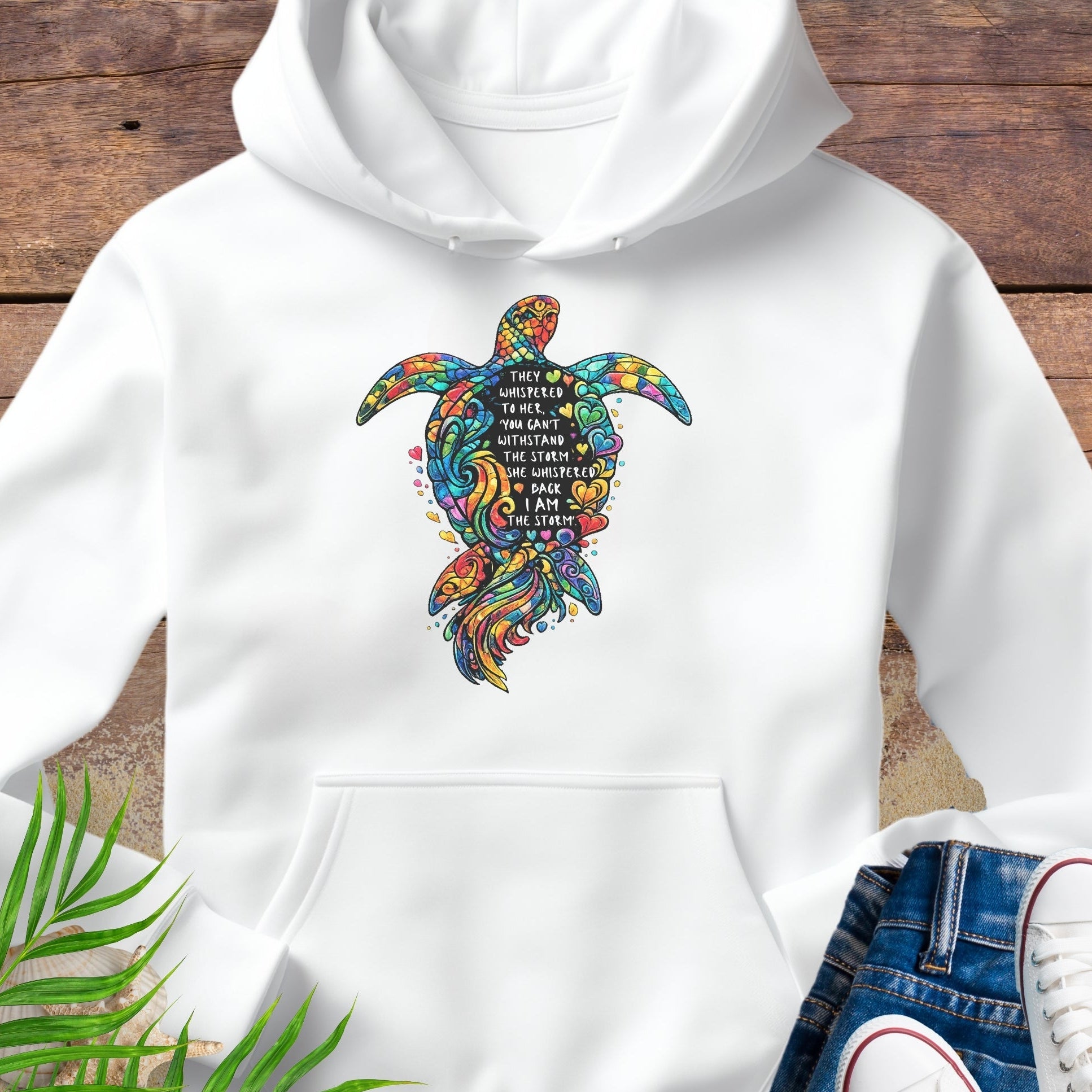 White Unisex hoodie featuring sea turtle design with “I Am the Storm” inspirational quote in ocean colors.