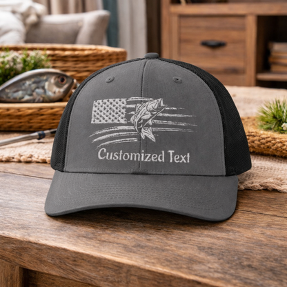 Gray and black cap with embroidered fish over the US Flag design and 'Customized Text'.