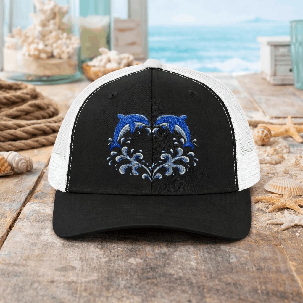 Black and white cap with two dolphins forming a heart embroidery design,