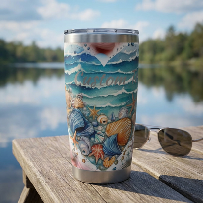 Stainless steel tumbler with ocean-themed design on a wooden table by a lake.