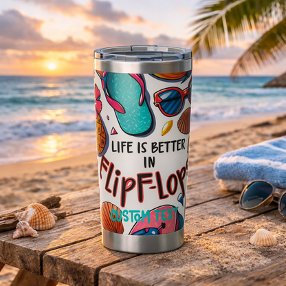 Tumbler with 'Life is better in flip-flops' design on a beach setting