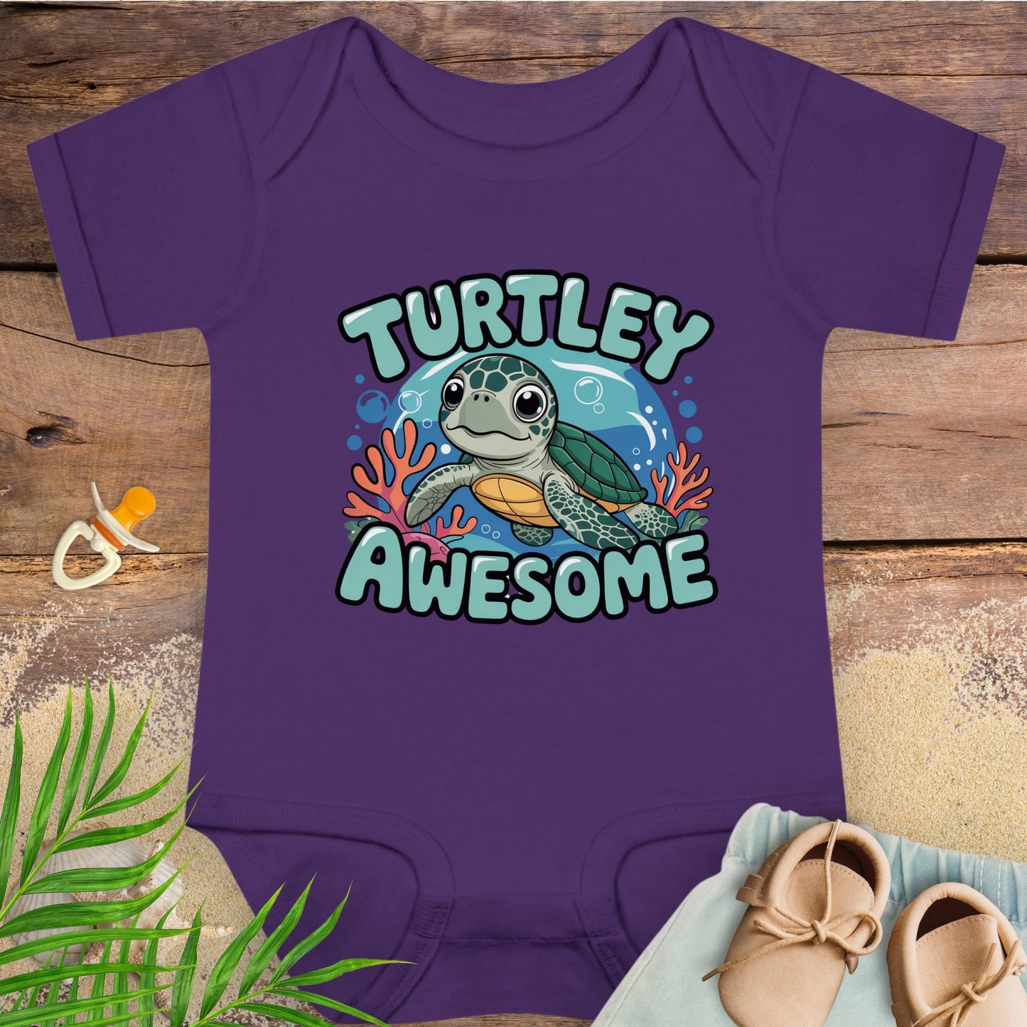 Purple baby onesie with a turtle design and 'Turtley Awesome' text on a wooden surface.