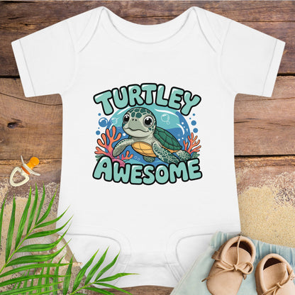 White baby onesie with a turtle graphic and 'Turtley Awesome' text on a wooden surface.
