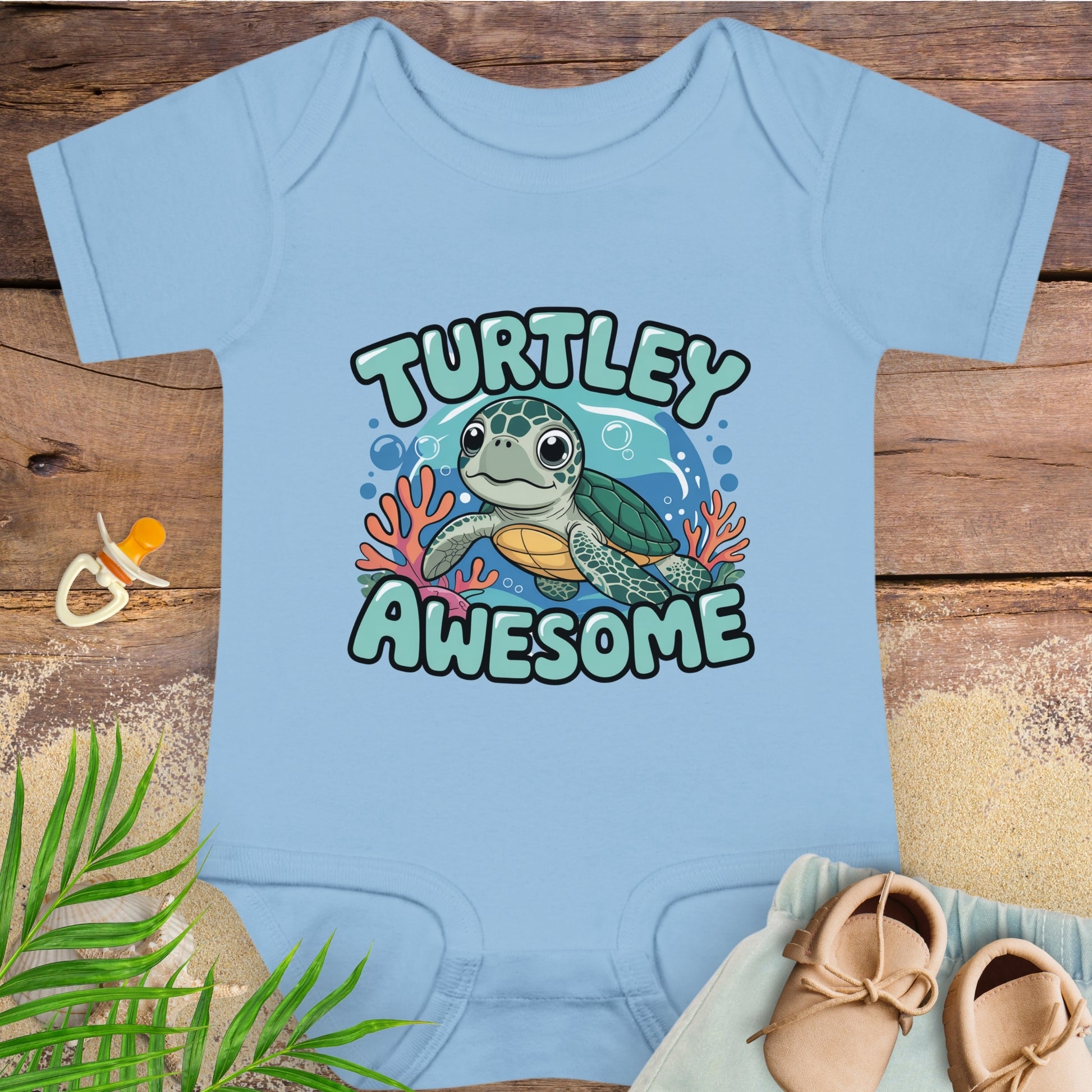 Light blue baby onesie with a turtle graphic and 'Turtley Awesome' text on a wooden surface.