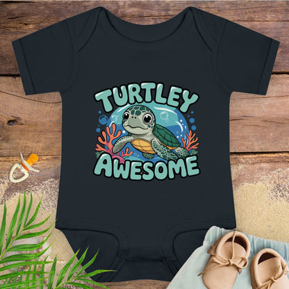 Black baby onesie with a turtle design and 'Turtley Awesome' text on a wooden surface.