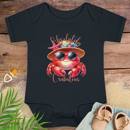 Black baby onesie onesie with a crab design and 'Absolutely Crabulous' text on a wooden surface.