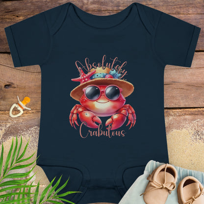 Navy blue baby onesie with a crab design and 'Absolutely Crabulous' text on a wooden surface.