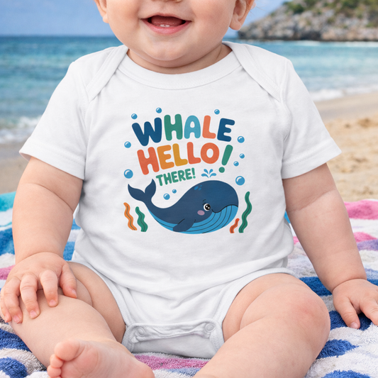Baby wearing a white onesie with a whale design and text 'Whale Hello There'.