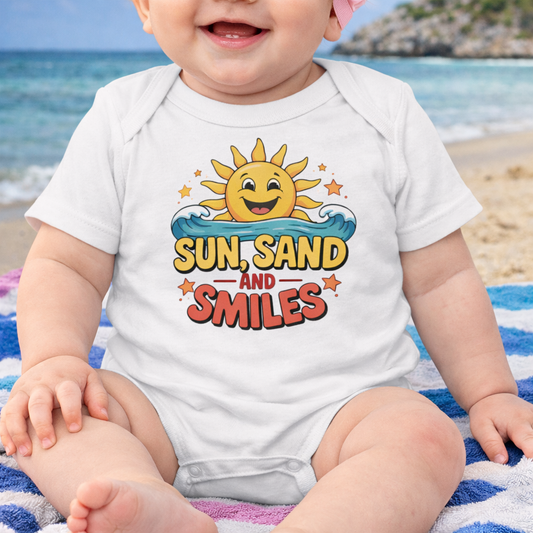 Baby wearing a onesie with 'Sun, Sand and Smiles' design on a beach.