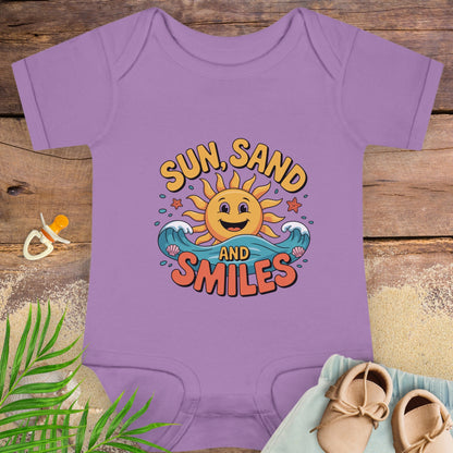 Purple baby onesie with 'Sun, Sand and Smiles' design on a wooden surface with a pacifier and shoes.