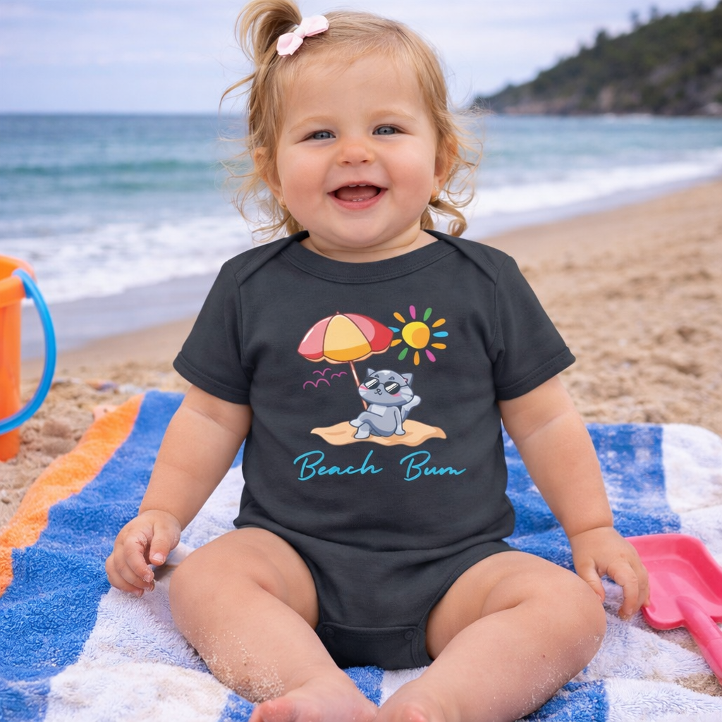 Child wearing a black onesie with a beach-themed design with a cat lounging on a sandy beach.