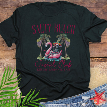 Black t-shirt with 'Salty Beach Social Club' design featuring a skeleton and flamingo on a wooden surface.