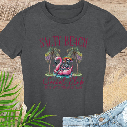 Dark gray t-shirt with 'Salty Beach Social Club' design featuring a flamingo and skeleton on a wooden surface.