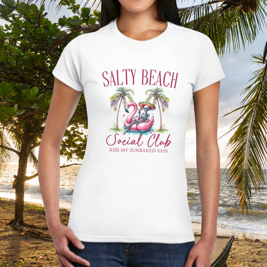 Person wearing a white t-shirt with 'Salty Beach Social Club' design on a beach background