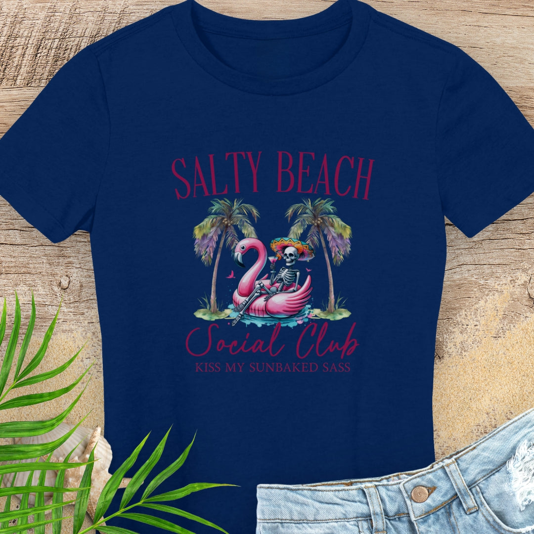 Navy blue t-shirt with 'Salty Beach Social Club' design featuring a skeleton and flamingo on a wooden surface.