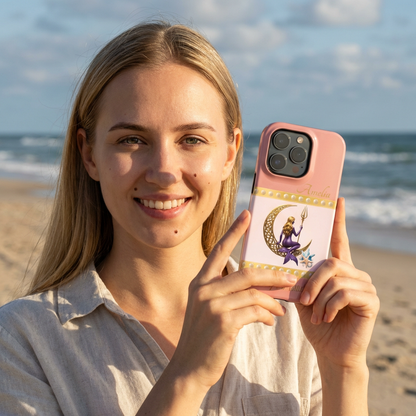 Woman holding a phone case with a design of a mermaid and crescent moon on a pink background,