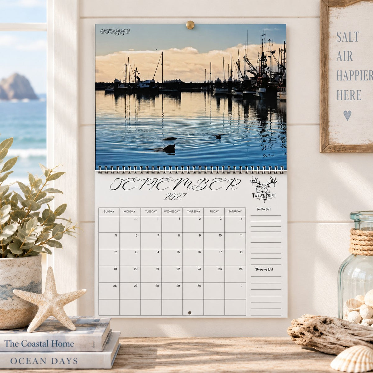 A wall-mounted September 2027 wall calendar monthly planning grid with to-do list and shopping list featuring Twelve Point Pics photography