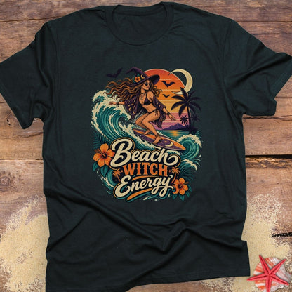 Black unisex t-shirt with “Beach Witch Energy” text, a witchy surfer girl, ocean wave, sunset, crescent moon, bats, palm trees, and tropical flowers.