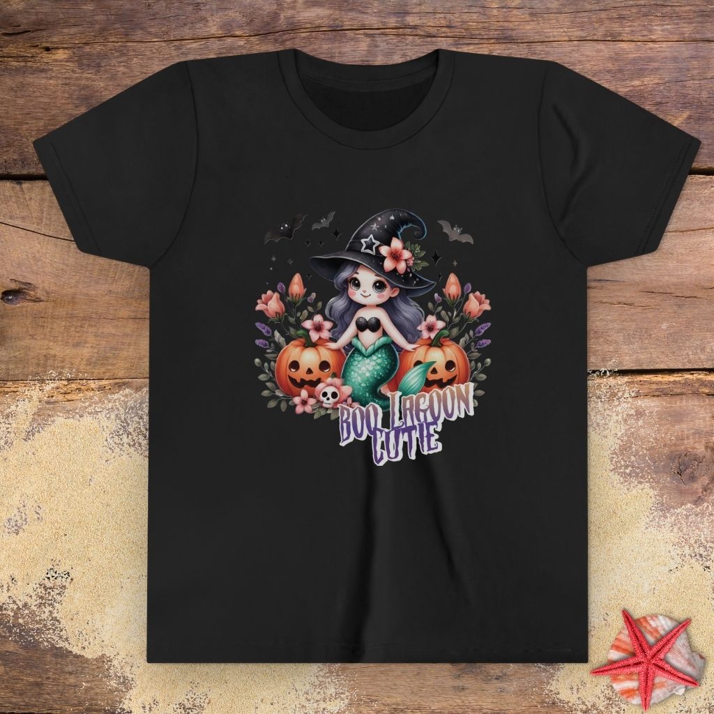 Black kids t-shirt with “Boo Lagoon Cutie” text, a cute witchy mermaid, pumpkins, bats, and flowers.