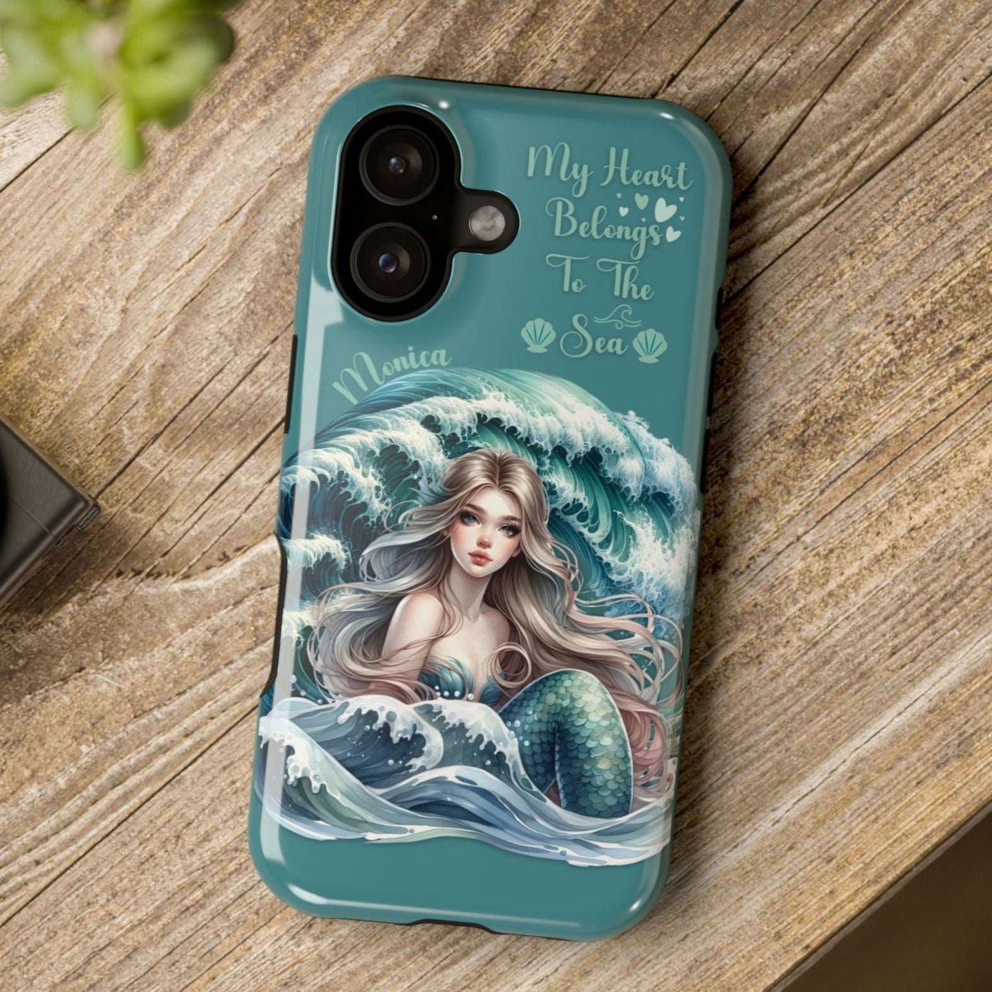 iPhone 17 case with mermaid design on a wooden surface