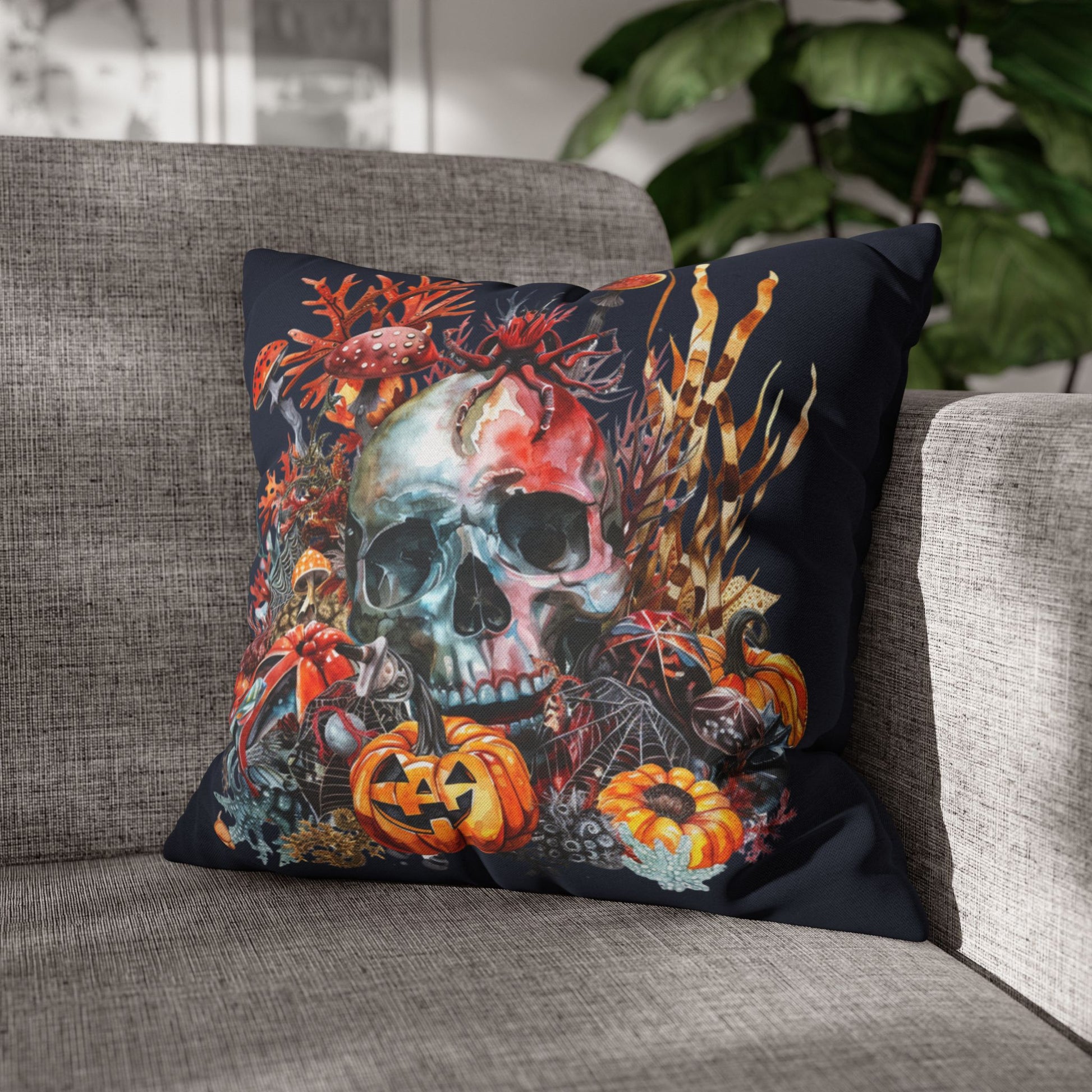 Decorative pillow with a skull and pumpkins design on a dark background.