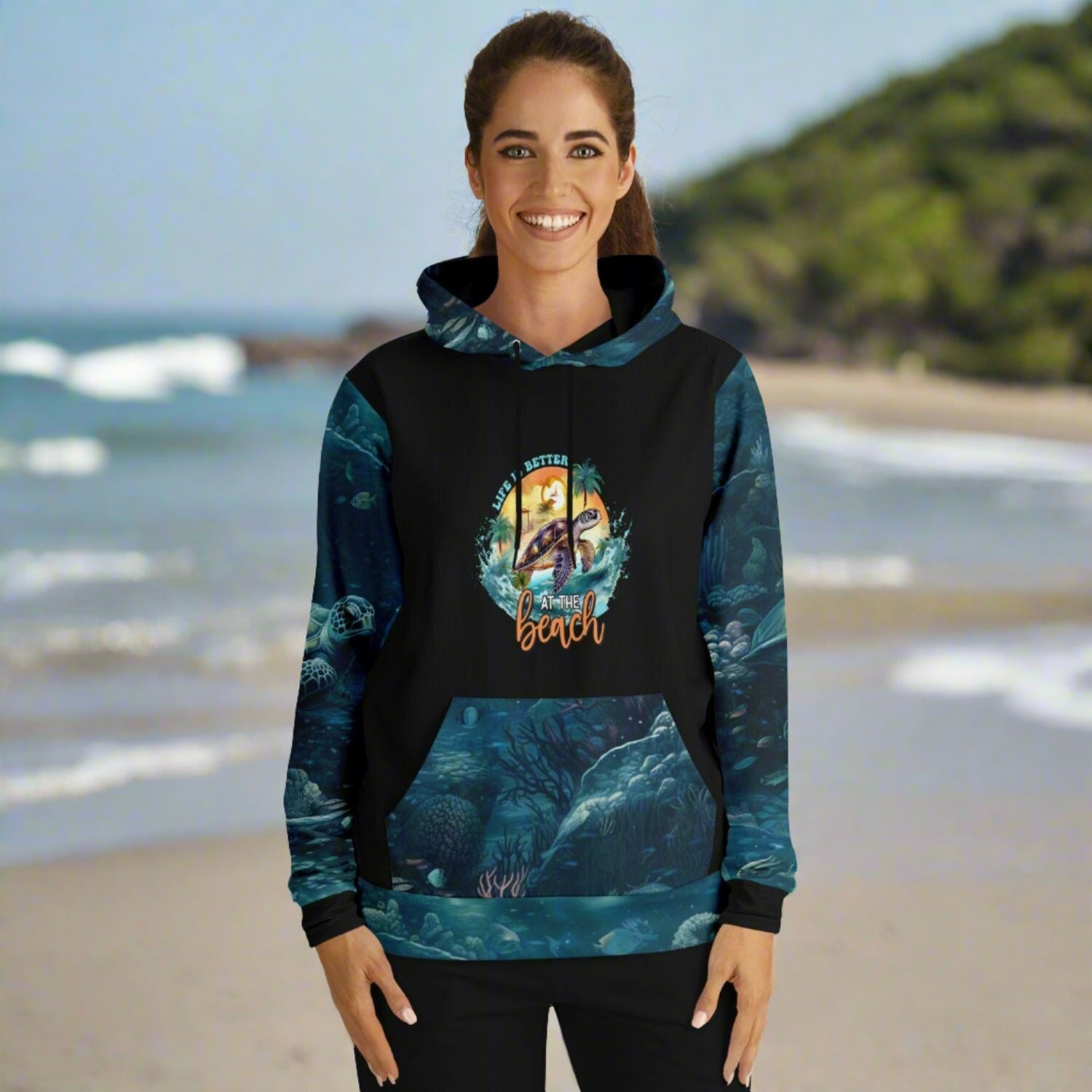 Custom hoodie with black front and back, underwater scene with sea turtles on sleeves, kangaroo pouch and hood. Sea turtle on front with text life's better at the beach