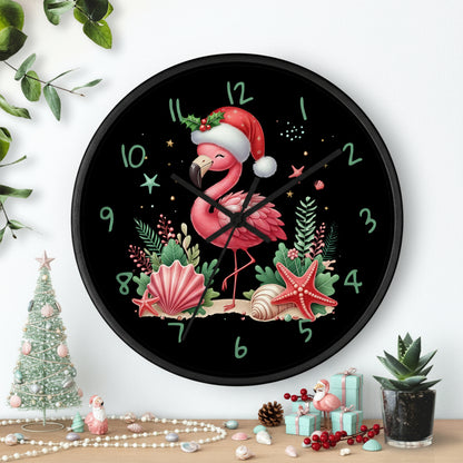 Wall clock with a festive flamingo design on a black background, featuring green plants and a plant pot.