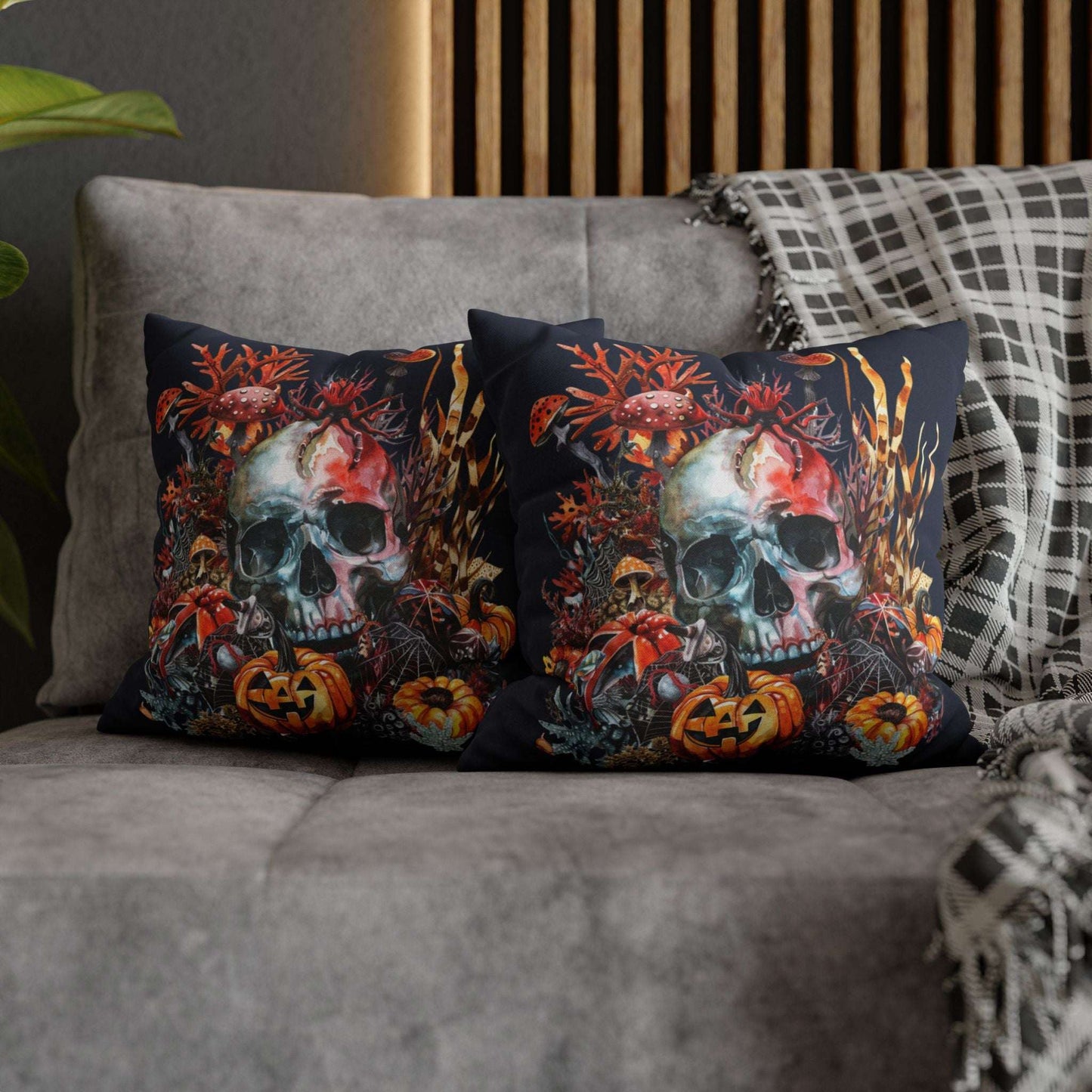 Decorative pillow cases with a double-sided  design of a skull and pumpkins design on a dark background.
