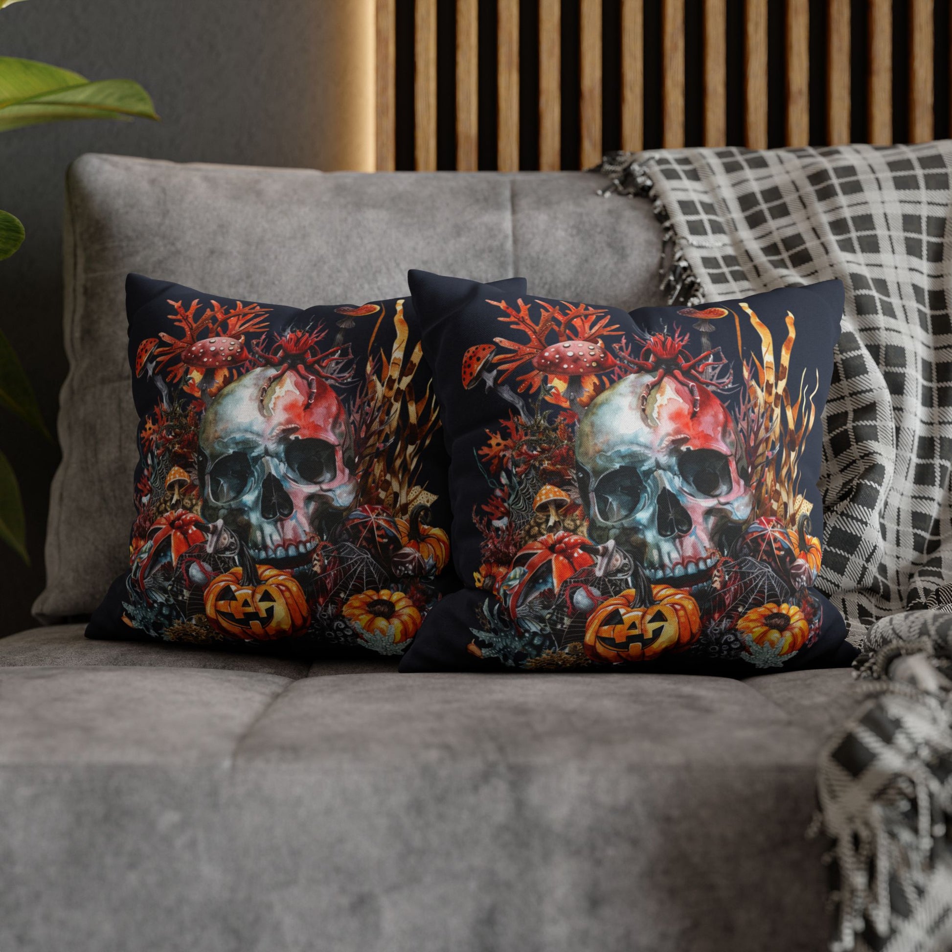 Decorative pillow cases with a double-sided  design of a skull and pumpkins design on a dark background.