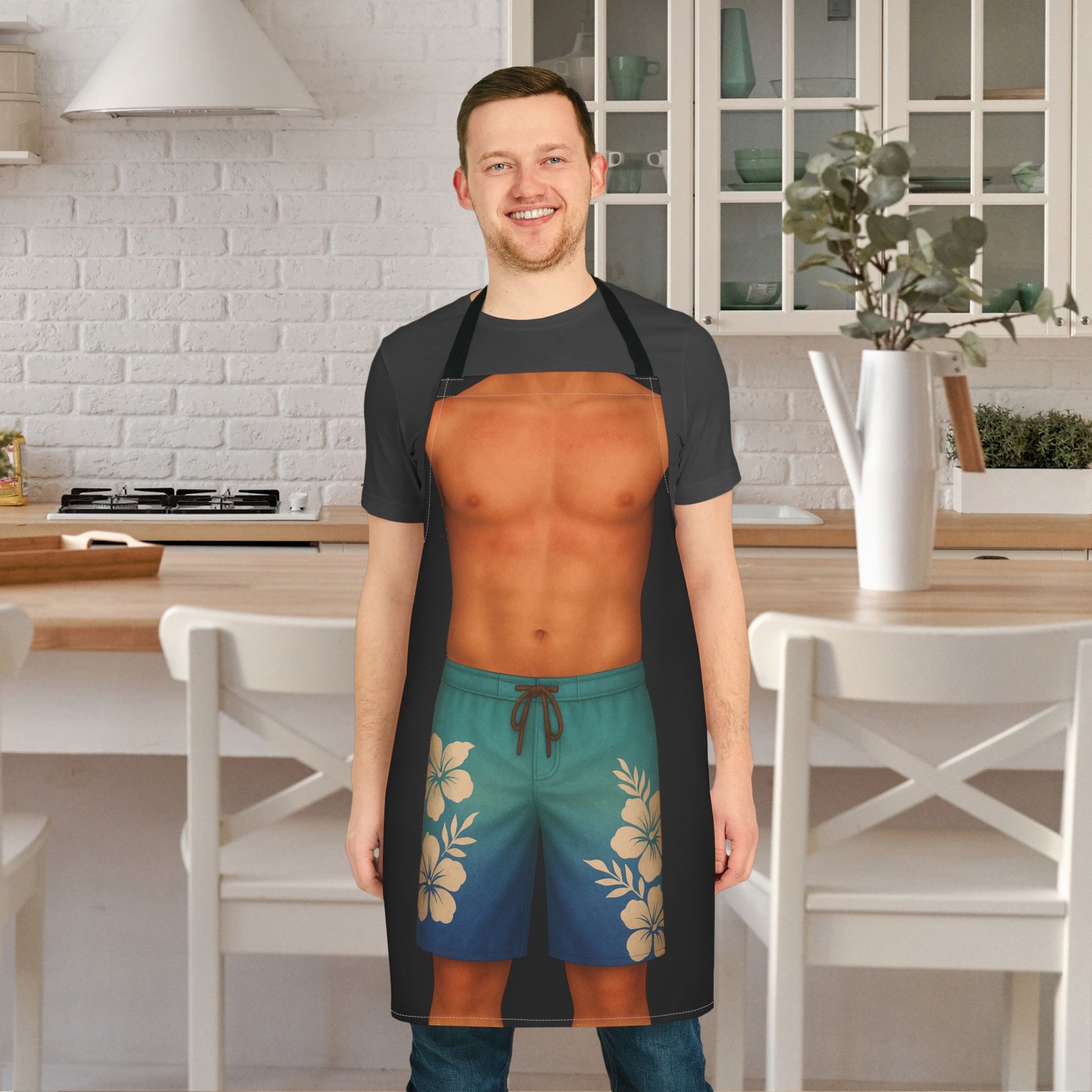 Man wearing a funny black apron with man surfer body wearing tropical blue shorts.