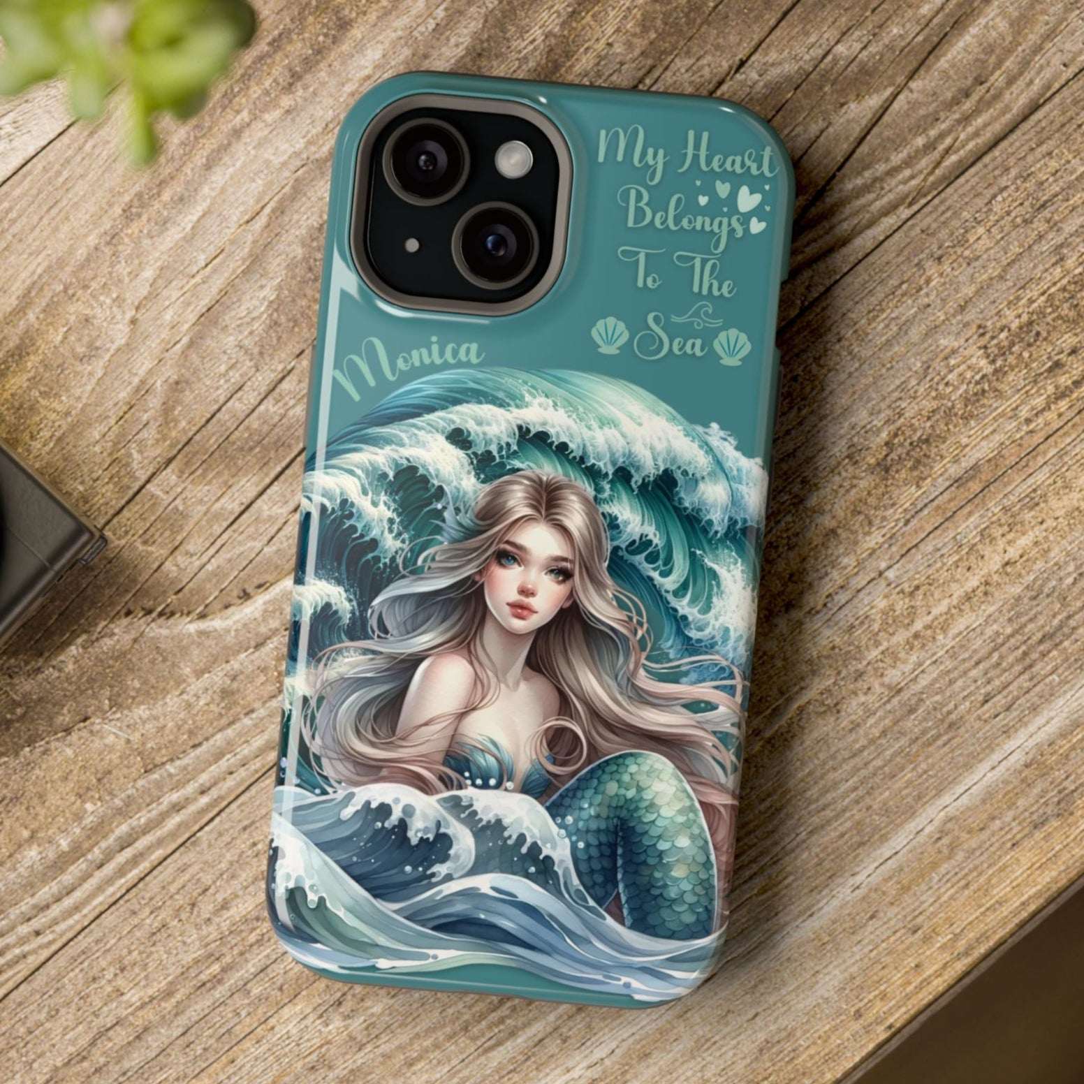 Phone case with mermaid design on a wooden surface